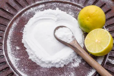 Soda a citron na tmavém talíři s dřevěnou lžící