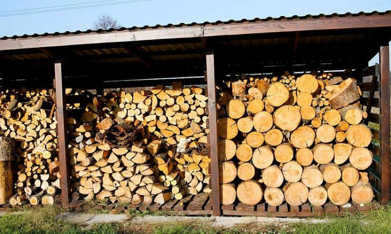 Správně uskladněné dřevo pod střechou pro suché palivo.
