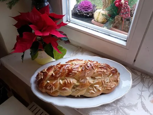 Zlatohnědá svatební chléb s mandlemi na talíři.